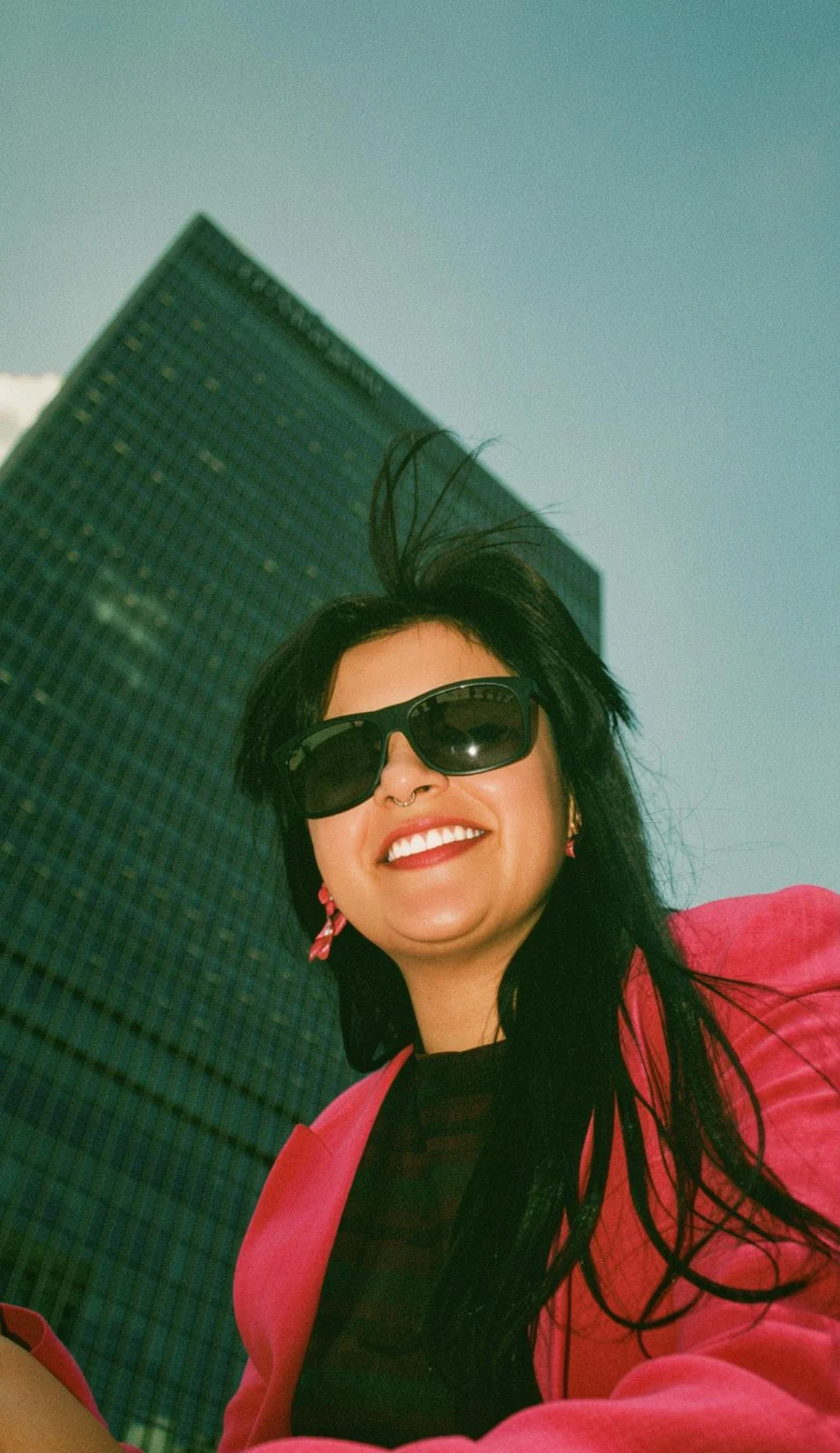 Andreea smiling in a pink blazer
