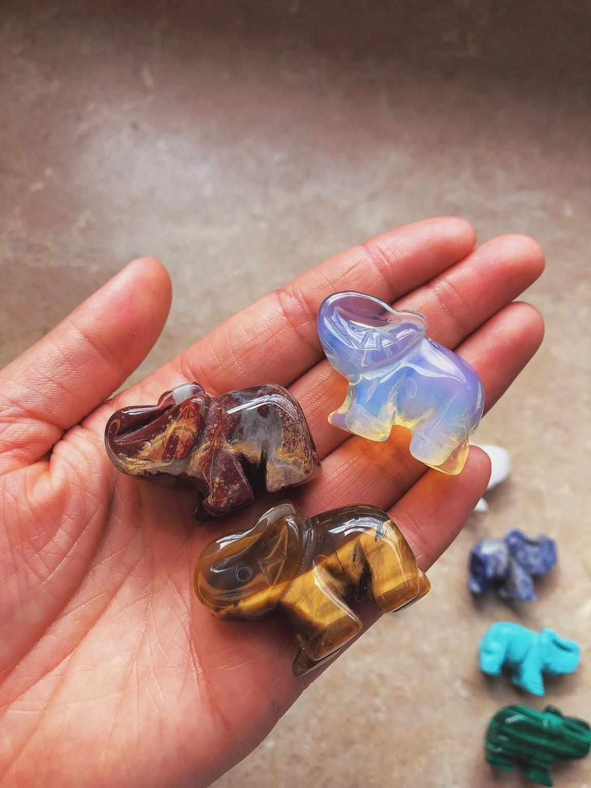 Carved elephants in the palm of a hand